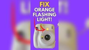 why is my instax camera flashing orange